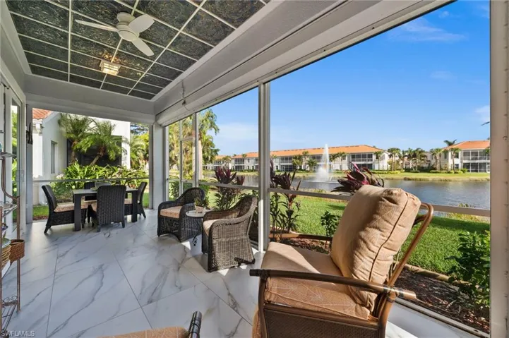 Sunroom featuring a water view and ceiling fan
