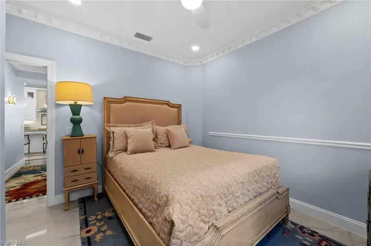 Bedroom featuring ceiling fan and crown molding