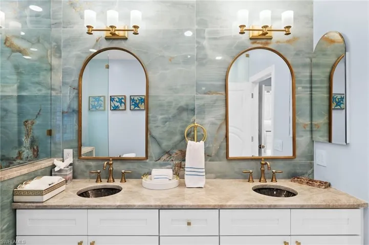 Bathroom featuring tile walls, tasteful backsplash, and vanity