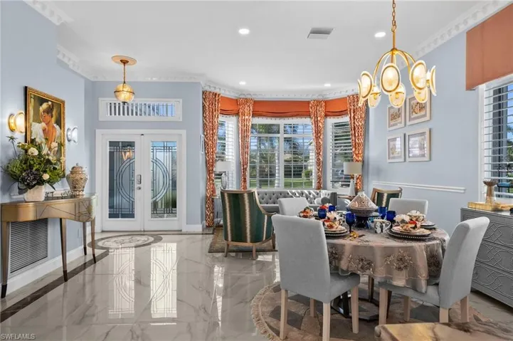 Dining room with  crown molding highlighting the seating area and spaciousness!