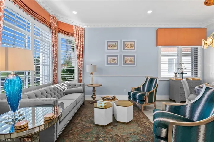 Living room with ornamental molding and a wealth of natural light