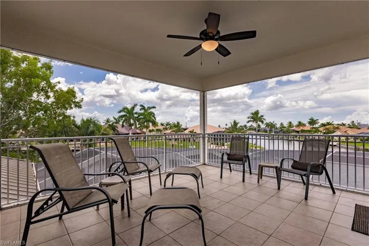 View of patio featuring a balcony and ceiling fan