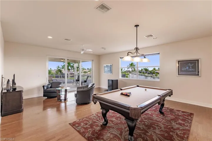 Rec room with ceiling fan, pool table, and light hardwood / wood-style flooring