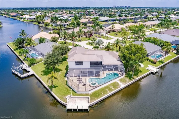 Birds eye view of property with a water view