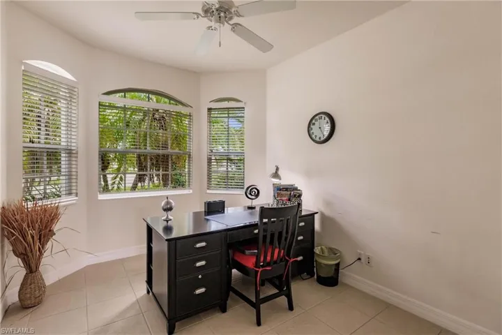 Tiled home office featuring ceiling fan