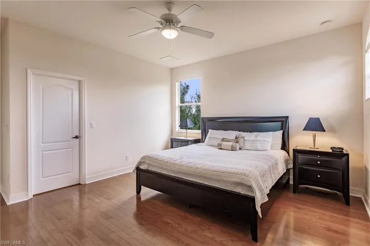 Bedroom with ceiling fan and hardwood / wood-style floors