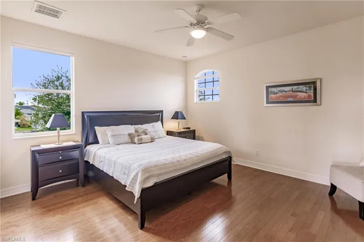 Bedroom with ceiling fan and hardwood / wood-style flooring