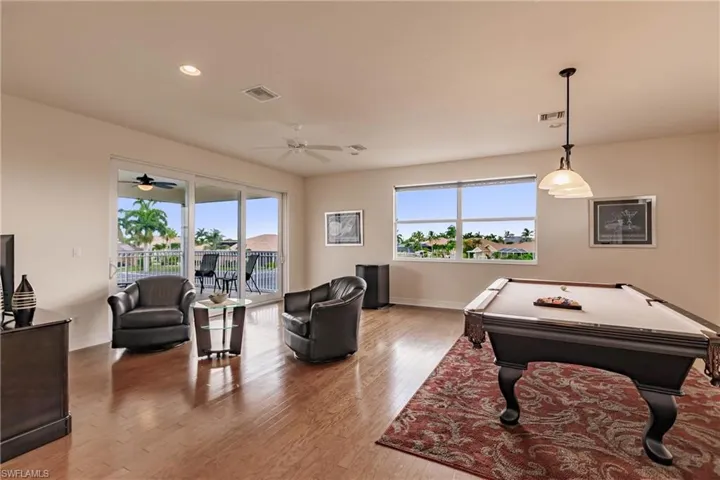 Game room with ceiling fan, light wood-type flooring, and pool table