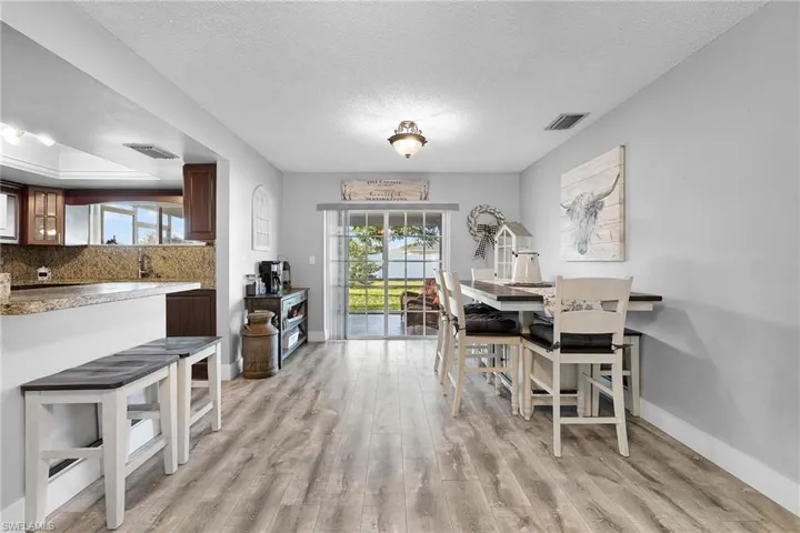 Dining room featuring light hardwood / wood-style floors and a textured ceiling