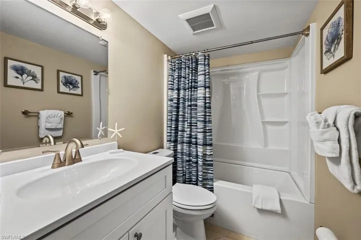 Full bathroom with vanity and shower / bathtub combination with curtain