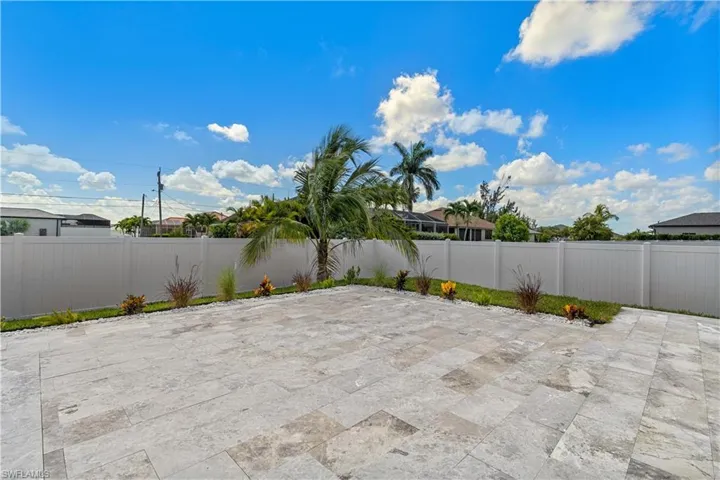 Marble pavers surround the pool, adding durability, elegance, and a clean, modern finish to the outdoor space.