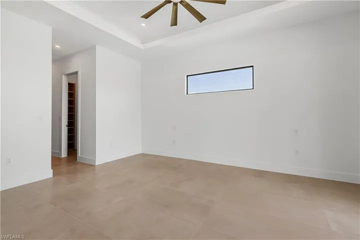 The contemporary primary bedroom offers a spacious, stylish retreat with modern finishes and natural light.
