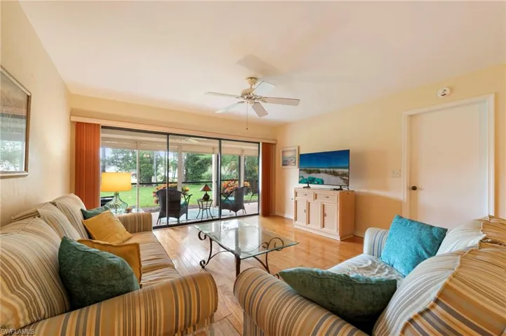 Living area with wood floors and slider access to lanai