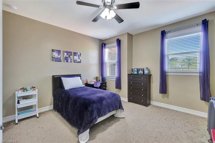 Bedroom featuring ceiling fan and light colored carpet