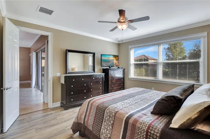 Bedroom featuring ornamental molding and ceiling fan