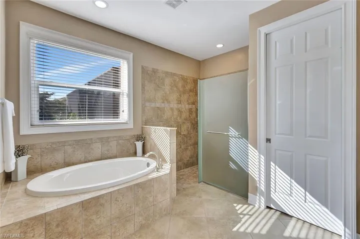 Master Bathroom featuring tile patterned flooring and independent shower and bath