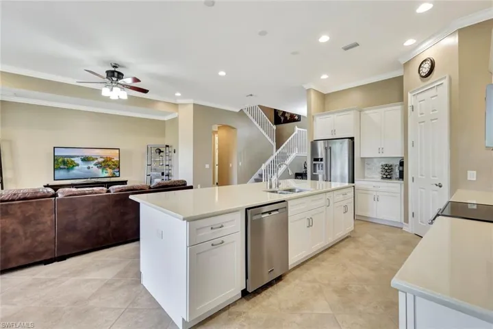 Kitchen with white cabinets, a kitchen island with sink, appliances with stainless steel finishes, and sink