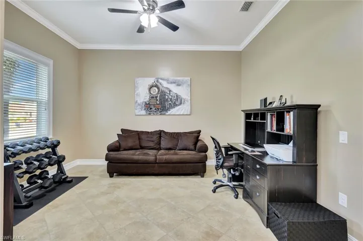 Office space with ceiling fan and ornamental molding