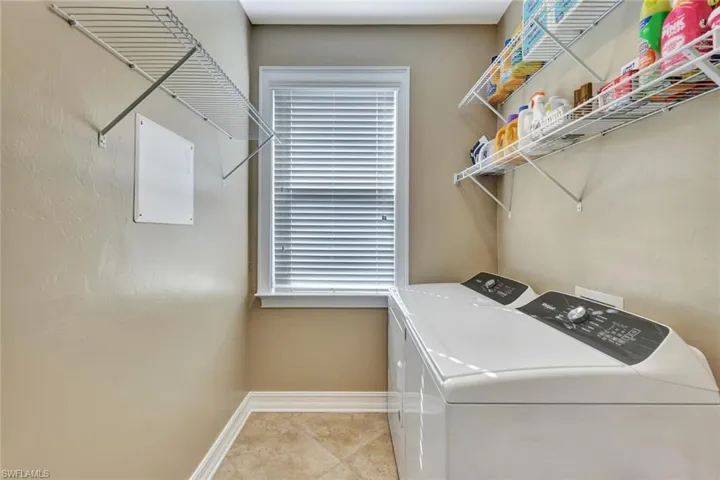 Washroom with washing machine and clothes dryer