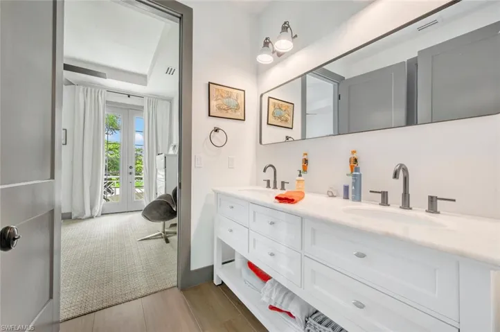 Bathroom with double vanity and french doors