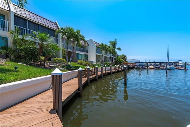 Dock area featuring a balcony and a water view