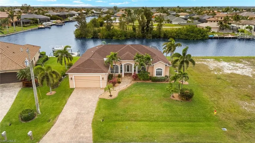 Aerial perspective of suburban area featuring a large body of water