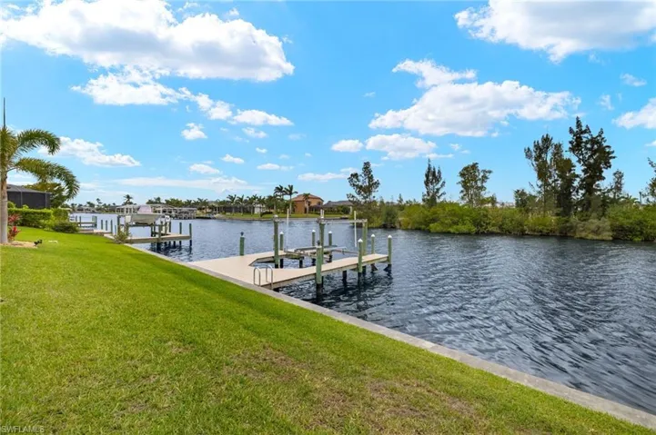 Dock featuring a water view, a yard, and boat lift