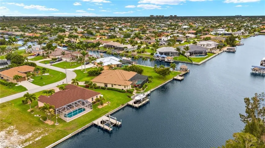 Aerial view of residential area featuring a nearby body of water