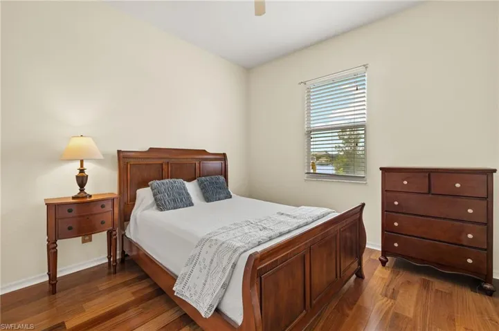 Bedroom featuring dark wood finished floors and a ceiling fan