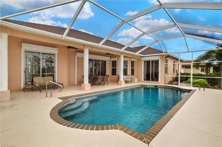 Outdoor pool with a sunroom, a patio, glass enclosure, and ceiling fan