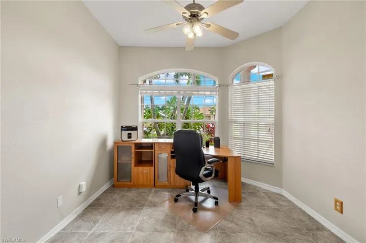 Office area with a textured wall and ceiling fan