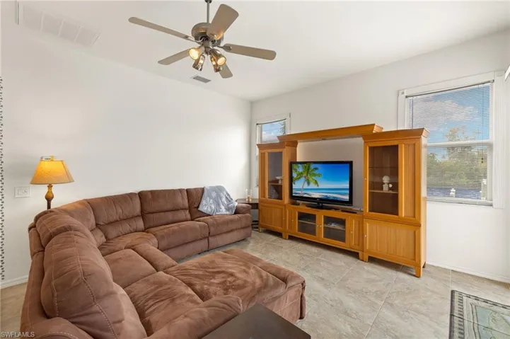 Living room with baseboards and a ceiling fan