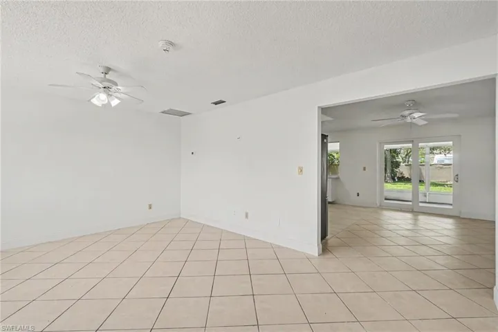 Tile flooring throughout, with a ceiling fan in each space