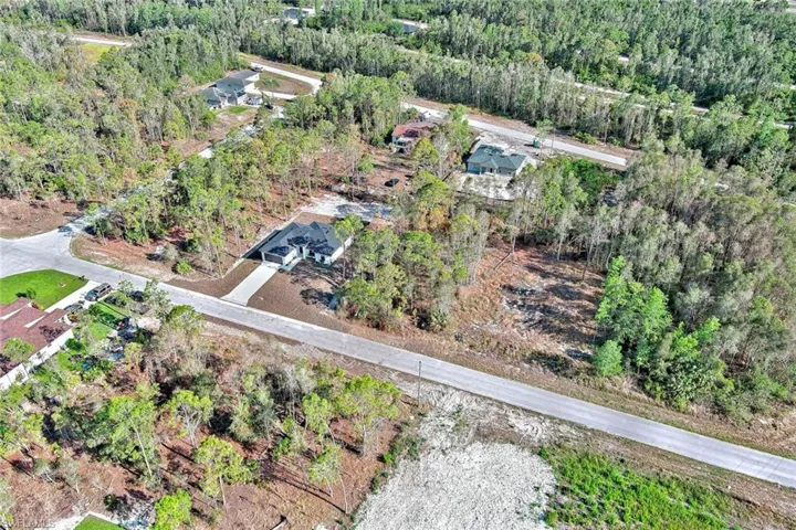 View of property location with a heavily wooded area