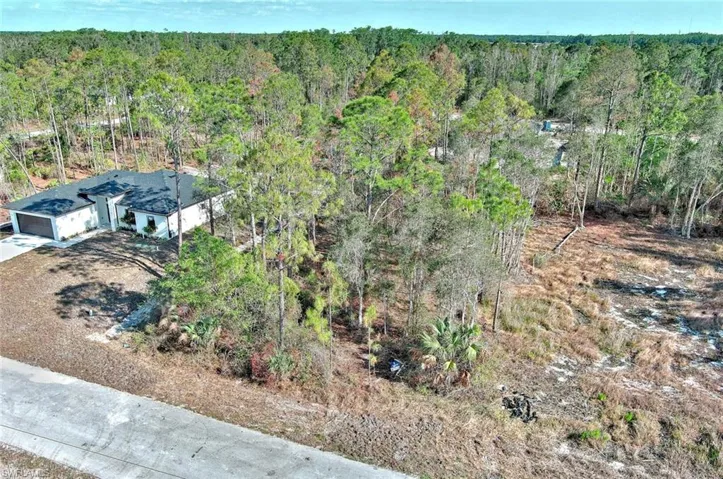 Aerial view of property's location with a forest