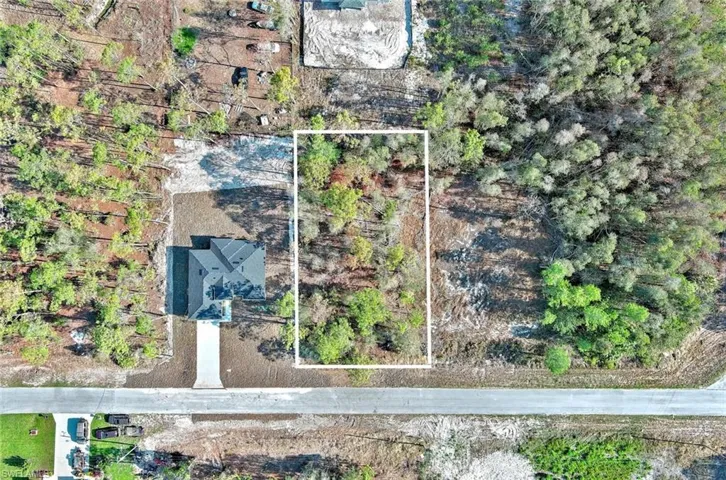 Aerial view of property and surrounding area featuring property boundaries highlighted