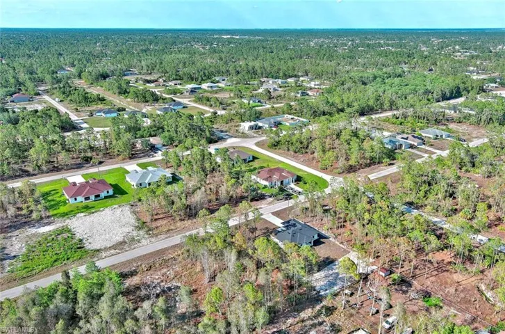 Aerial view of property's location featuring nearby suburban area
