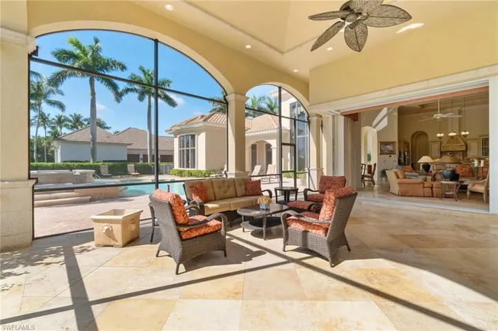 View of patio / terrace with ceiling fan, an outdoor living space, and glass enclosure