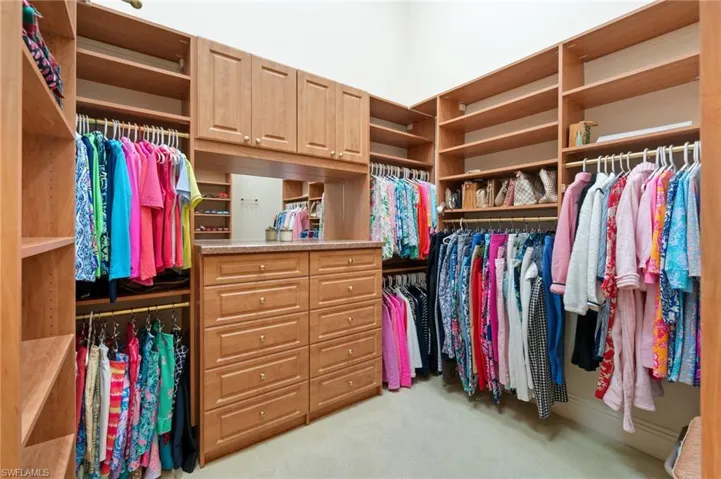 Walk in closet featuring light carpet