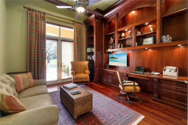 Home office featuring dark hardwood / wood-style floors and ceiling fan