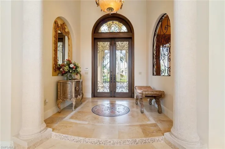 Foyer featuring french doors and decorative columns