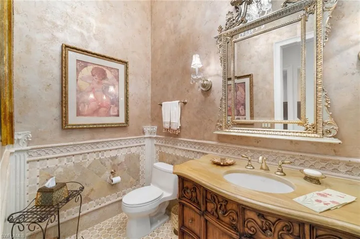 Bathroom with vanity, tile walls, and toilet