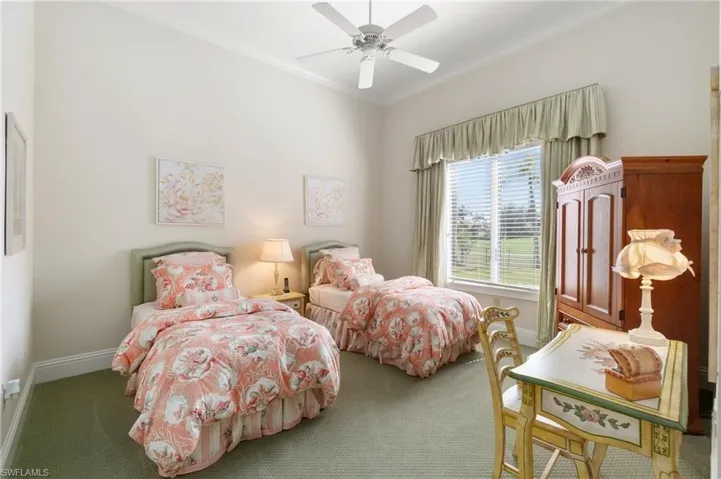 Bedroom featuring crown molding, ceiling fan, and dark carpet