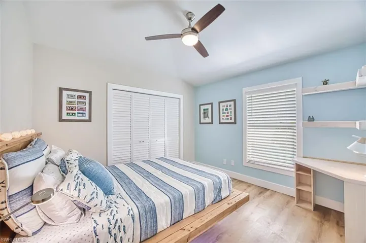Bedroom featuring wood finished floors, ceiling fan, and a closet