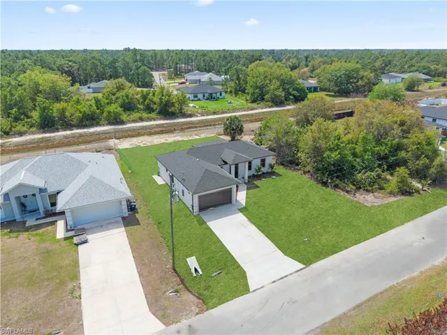 Aerial view of residential area featuring a heavily wooded area