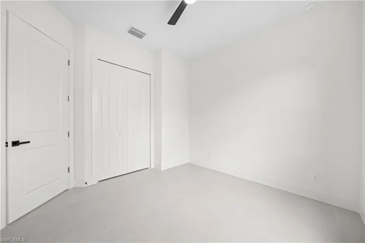 Unfurnished bedroom with a closet and a ceiling fan