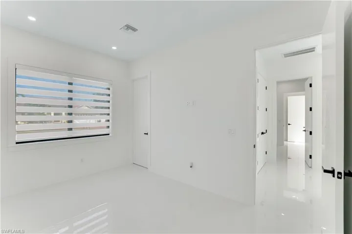 Empty room with visible vents and recessed lighting