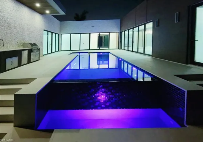 View of pool featuring grilling area