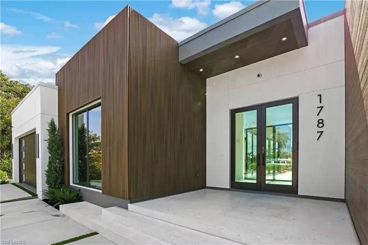 View of side of property featuring french doors, a patio area, and stucco siding