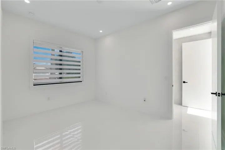 Empty room featuring recessed lighting and visible vents
